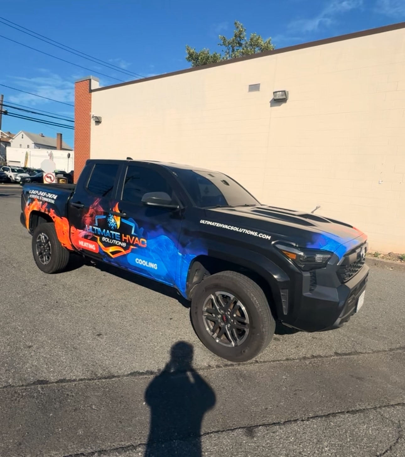 Black pickup truck with Ultimate HVAC Solutions flame and ice wrap